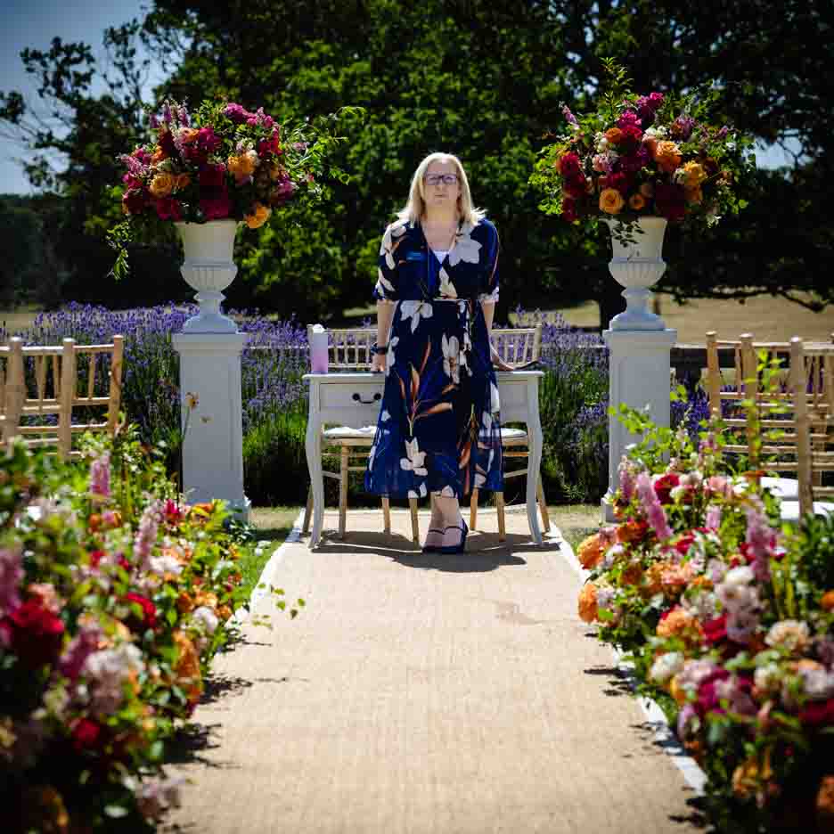 Deb Reed Celebrant based in Colchester Essex sitting smiling before a wedding.